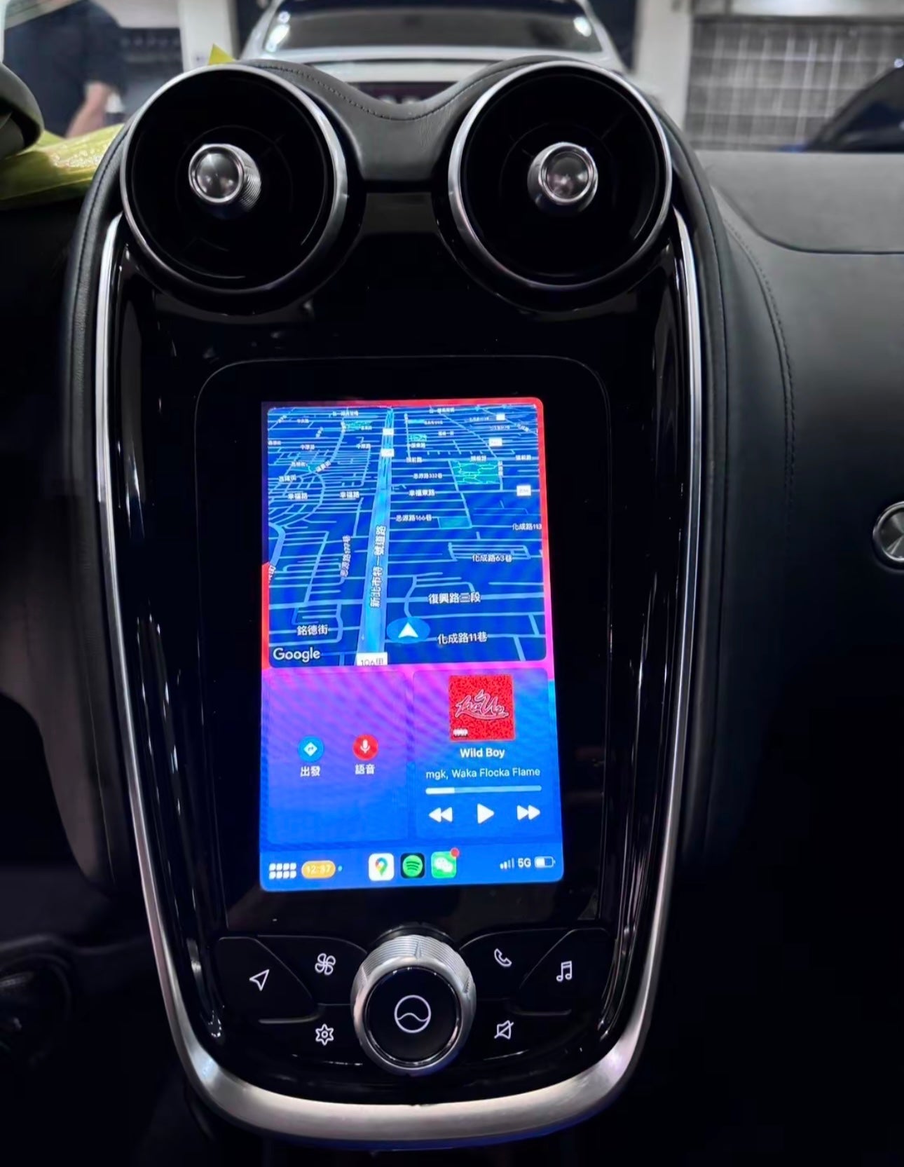 Mclaren IRIS Car infotainment system with a CarPlay navigation screen displaying a map.