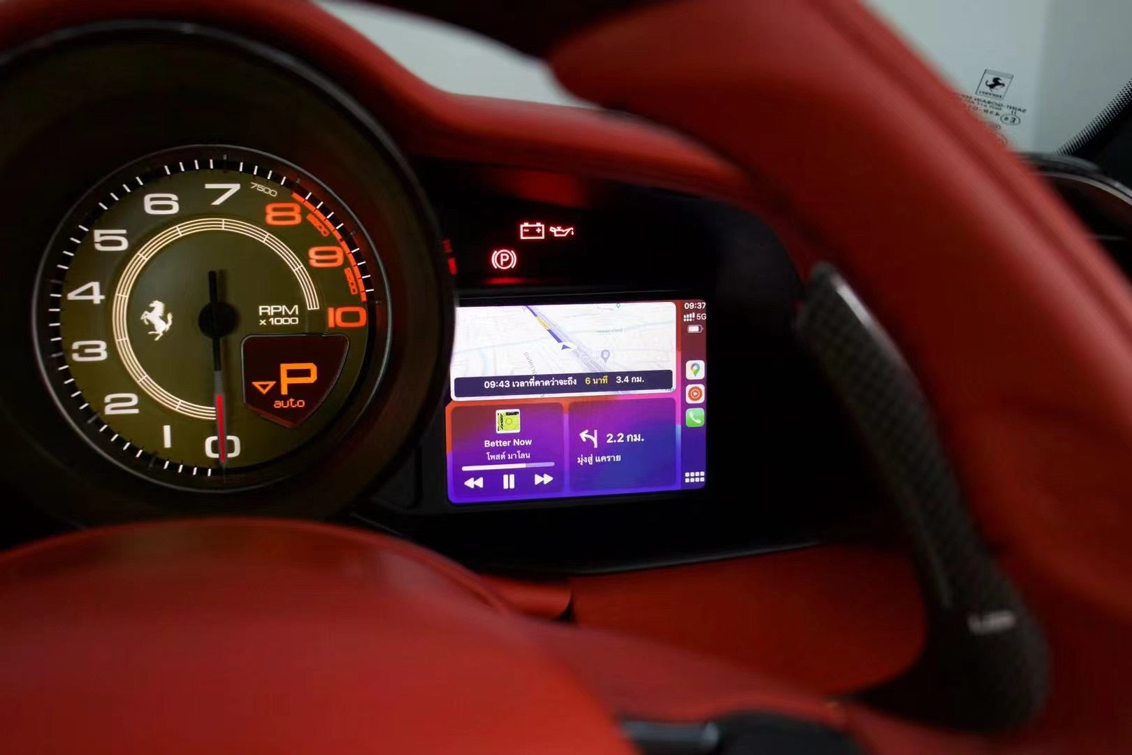 Close-up of a F12 digital dashboard with a visible brand logo.